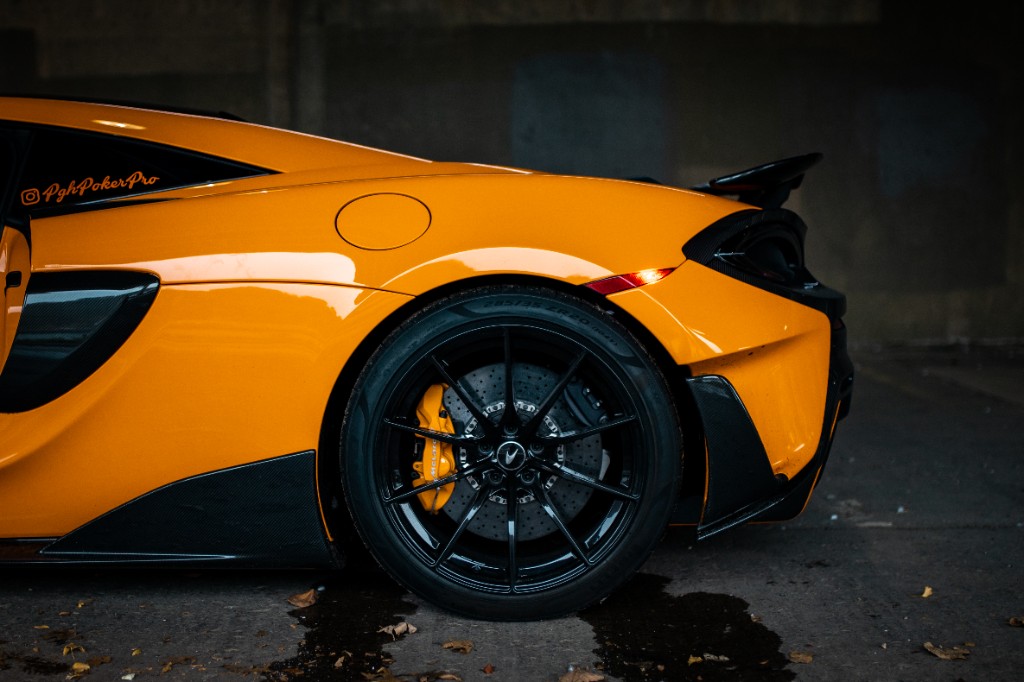 Close view of McLaren rear wheel and rear body flare in wet conditions